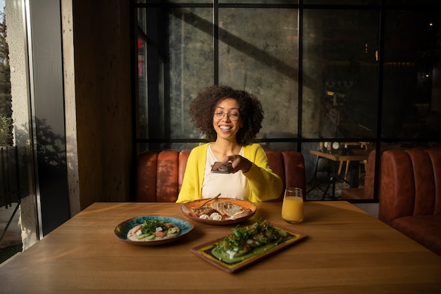 medium shot smiley woman sitting at table