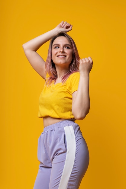 medium shot smiley woman with yellow background