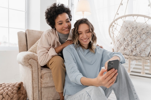 Medium shot smiley women at home