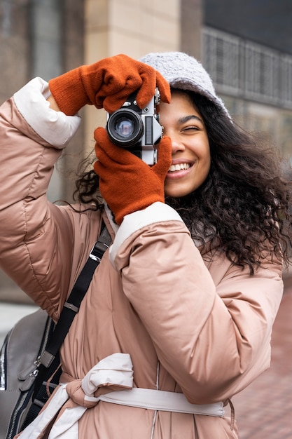 Foto medium shot smileyvrouw die foto's maakt