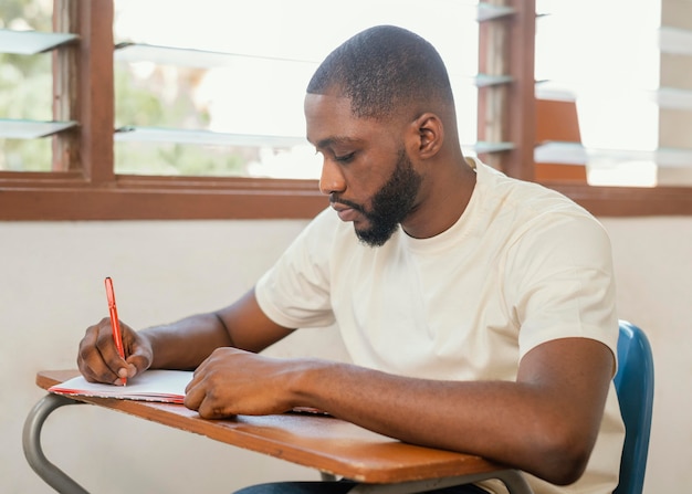 Medium shot student taking notes