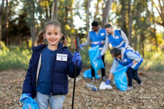 Medium shot volunteers helping environment