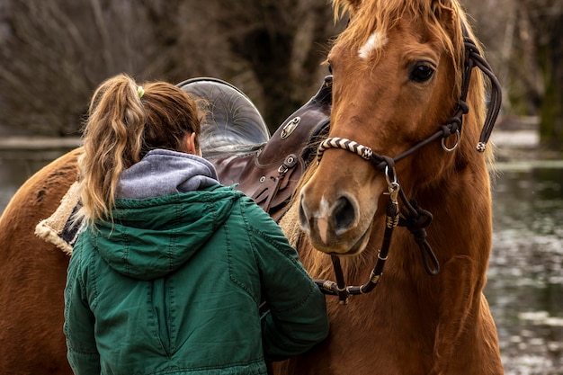 Medium shot vrouw en paard buiten