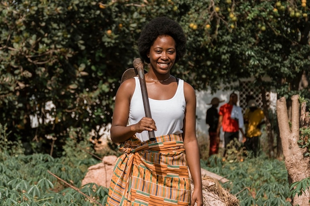 Photo medium shot woman carrying spade