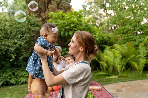 Medium shot woman holding baby