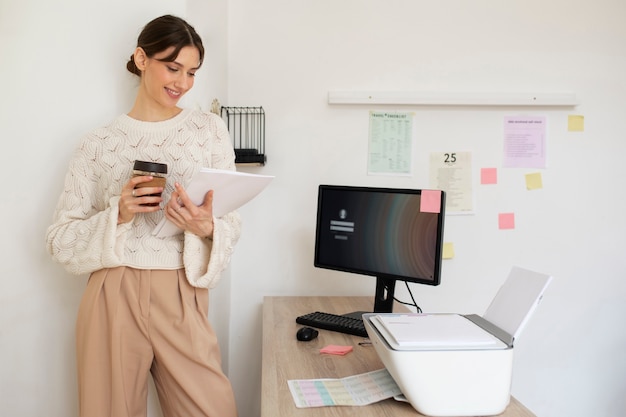 Medium shot woman holding coffee cup