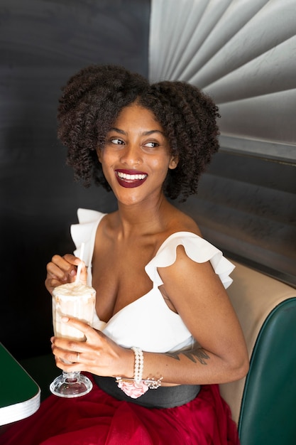 Medium shot woman holding drink