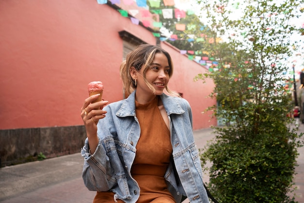 Medium shot woman holding ice cream