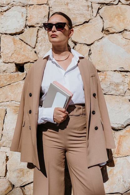 Medium shot woman holding notebooks