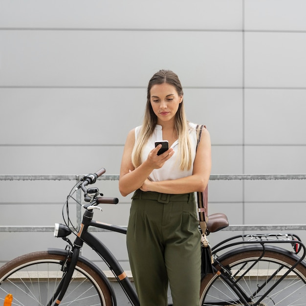 Medium shot woman holding phone