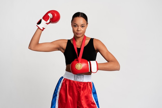 Medium shot woman practicing boxing