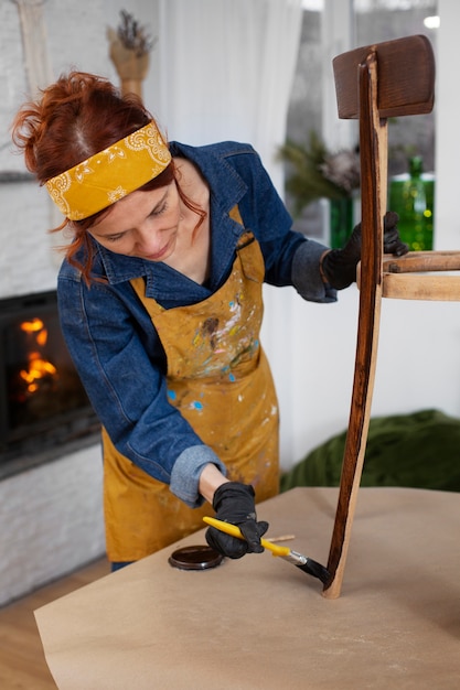 Medium shot woman restoring furniture