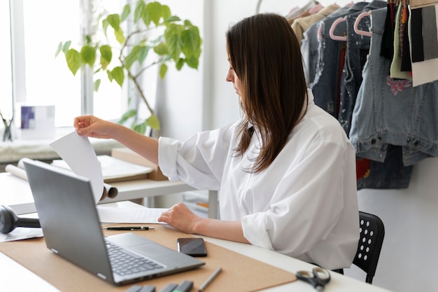 Medium shot woman sitting at desk