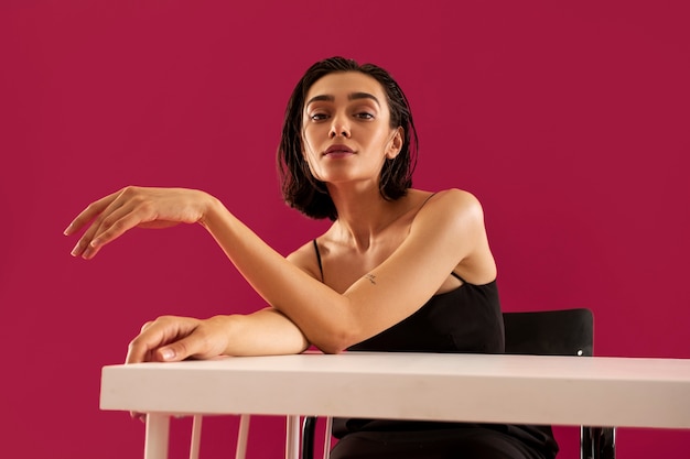 Medium shot woman sitting at table