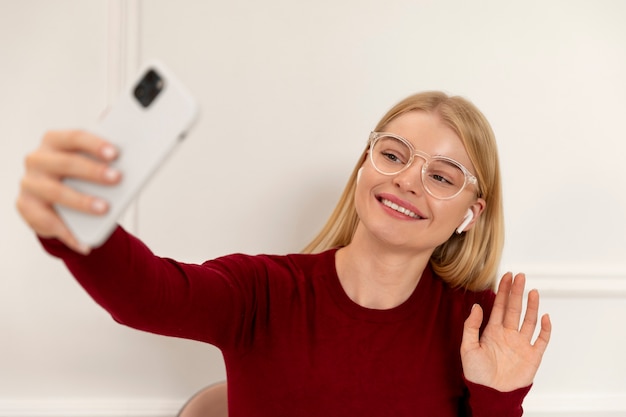 Medium shot woman taking selfie