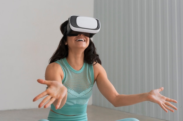 Medium shot woman training with vr glasses on