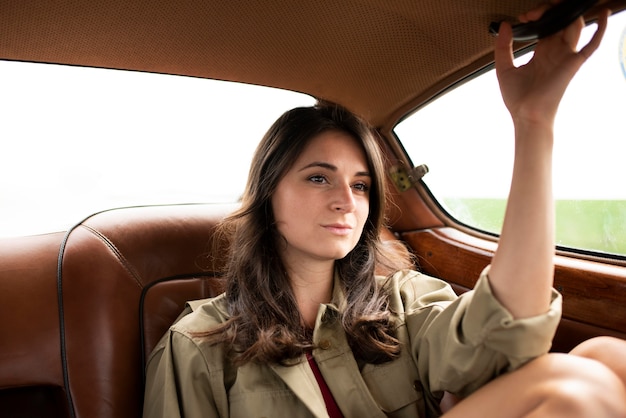 Medium shot woman traveling by car