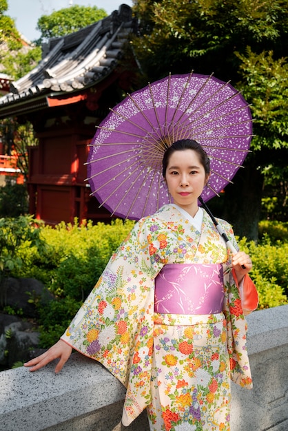 Medium shot woman using wagasa umbrella