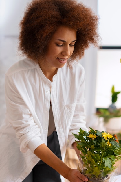 Medium shot woman with beautiful flowers