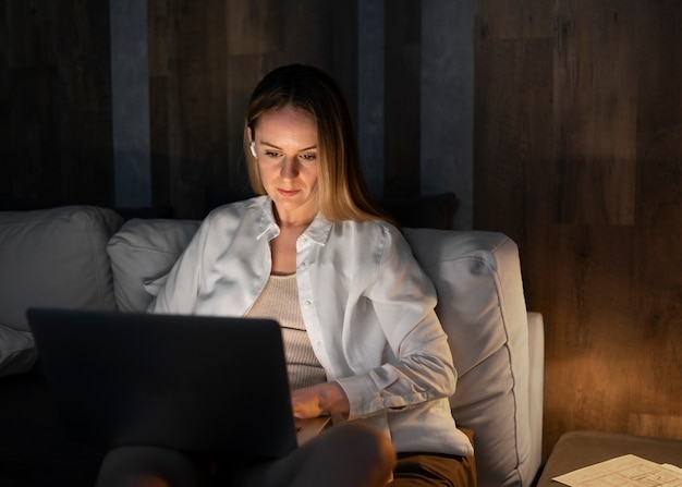 Medium shot woman working on laptop