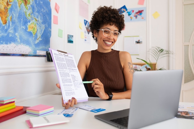 Medium shot woman working in  travel agency