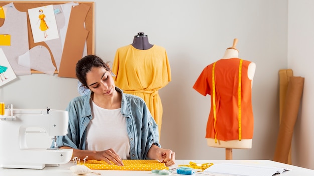 medium shot woman working with fabric