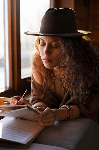 Medium shot woman writing music