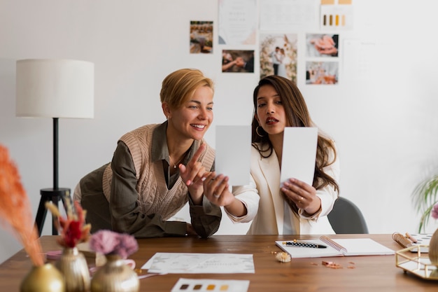 Medium shot women working as wedding planners