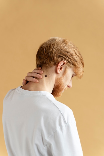Medium shot young man with mole on neck
