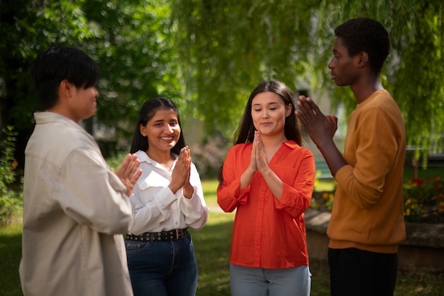 Photo medium shot young people praying outdoors