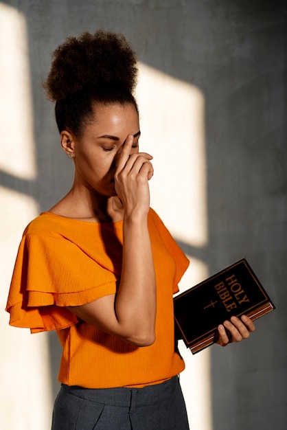 Medium shot young woman praying