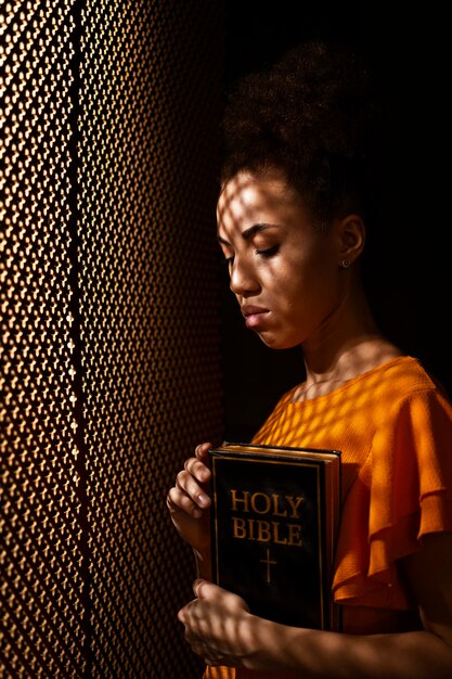 Medium shot young woman praying