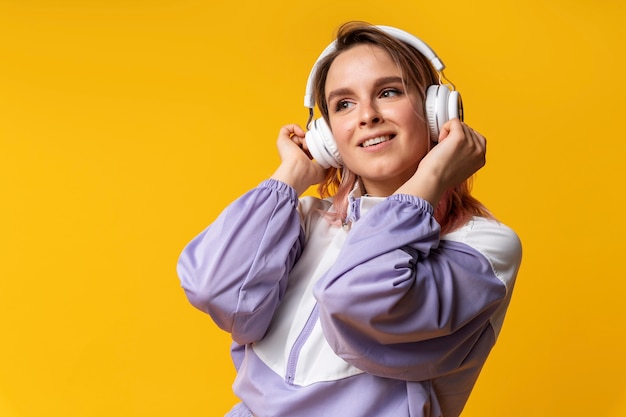 Medium shot young woman wearing headphones