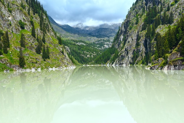 Meer met troebel water vormde de dam. Zomer berglandschap (Alpen, Zwitserland)