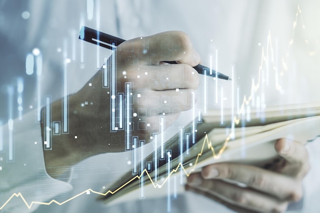 Meervoudige blootstelling van abstracte creatieve financiële grafiek met handschrift in dagboek over achtergrondonderzoek en analyseconcept