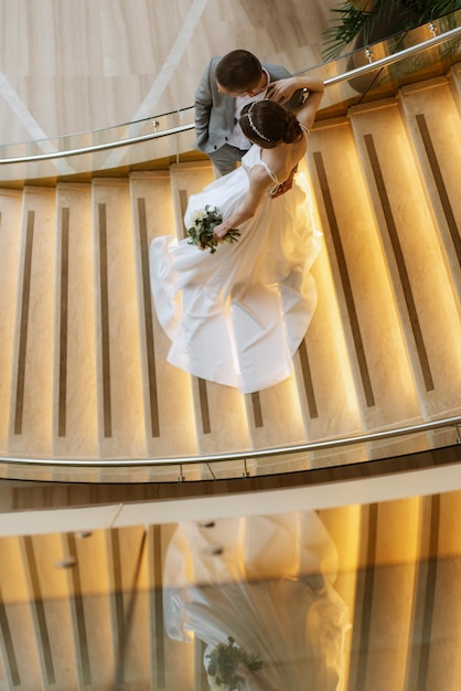 Photo meeting of the bride and groom on the hotel stairs