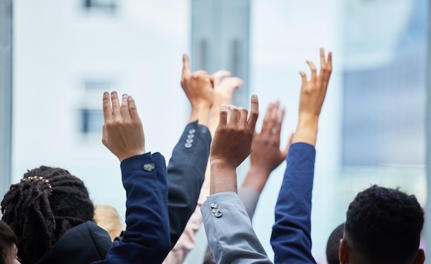 Meeting conference and business people raise hands for speaking at a corporate seminar Diversity tradeshow and closeup of group of employees with a question gesture at a convention in the office