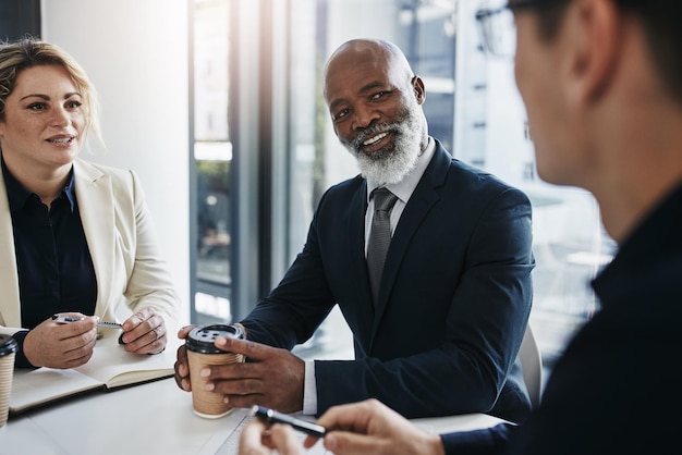 Photo meeting discussion and black man leader talking to his colleagues at a business team analysis teamwork diversity and african male manager speaking to coworkers about report project and proposal