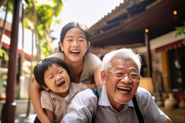 Photo meeting of grandfather and grandchildren an elderly asian man and his grandchildren are happy together they hug and rejoice at meeting each other caring for the elderly children visit old people