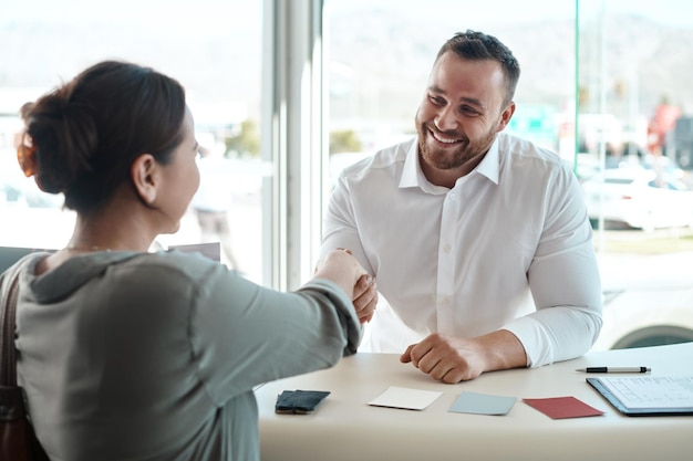 Meeting handshake and business people in partnership clients contract and agreement sign for career success Happy professional man shaking hands with woman in job hiring recruitment and interview