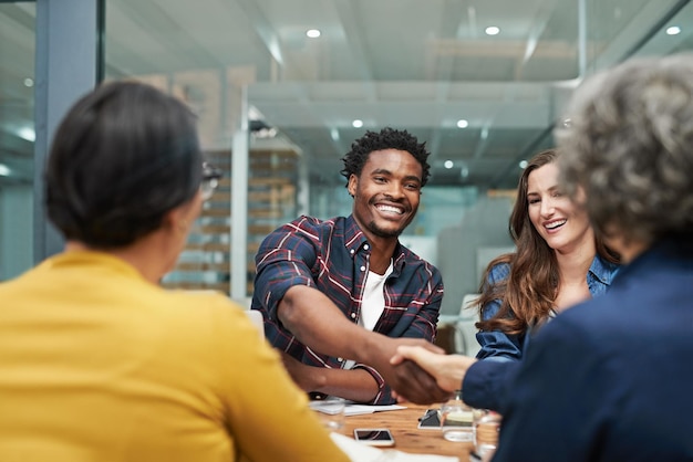 Meeting man and handshake with team for sales deal success and b2b collaboration Boardroom agree and business people for investment company finance and negotiation with thank you in workplace