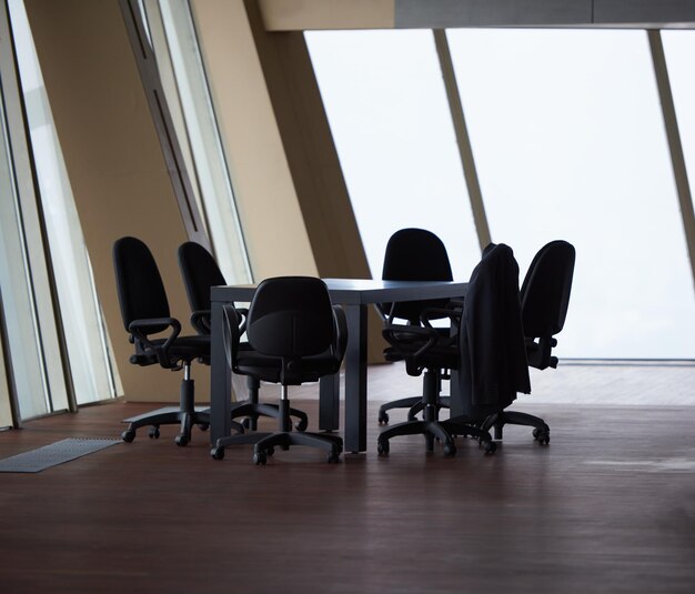 meeting office room with white modern table and orange chairs with glass wall