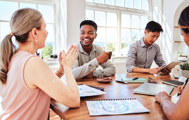 Photo meeting planning and teamwork with a business man and his team talking in an office boardroom strategy collaboration and training with an employee group sitting a table to talk mission and vision