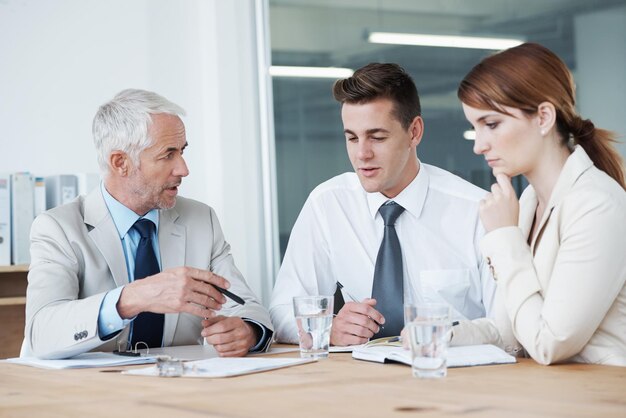 Photo meeting planning or training with manager and team in boardroom of office for coaching seminar collaboration strategy or upskill development with business man teaching employee group at workplace