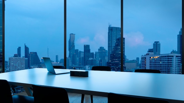 Photo meeting room and workplace with notebook laptop comfortable work table in office windows and bangkok city view.