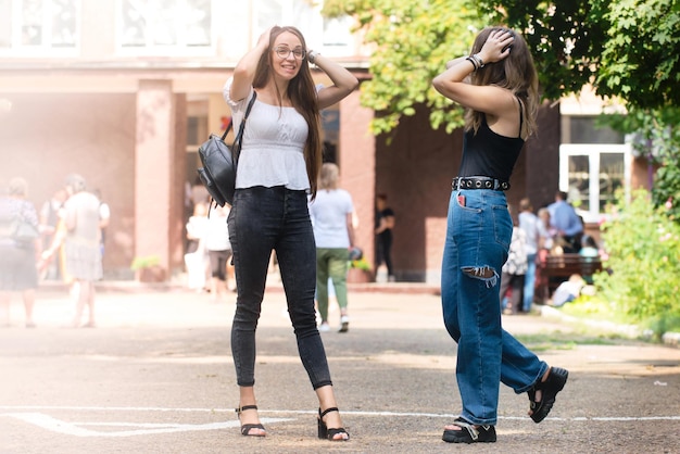 Meeting of two emotional girls in the city