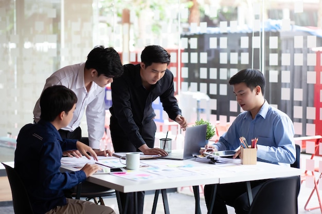 Meeting of young asian business people who are committed to work creative business team sitting working together at office