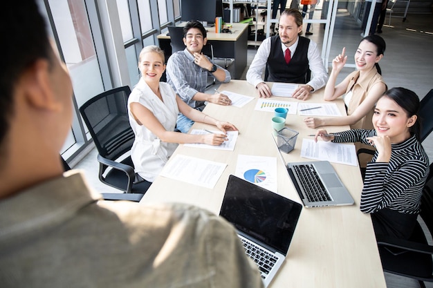 Meetings and consultations in the company's meeting room present by business man. Conference to analyze and find the progress of the organization.