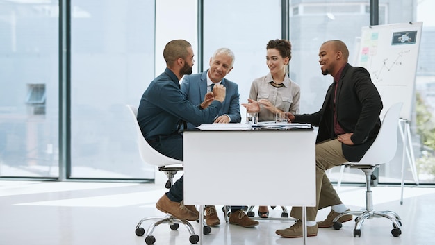 The meetings going well Full length shot of a group of businesspeople in the boardroom