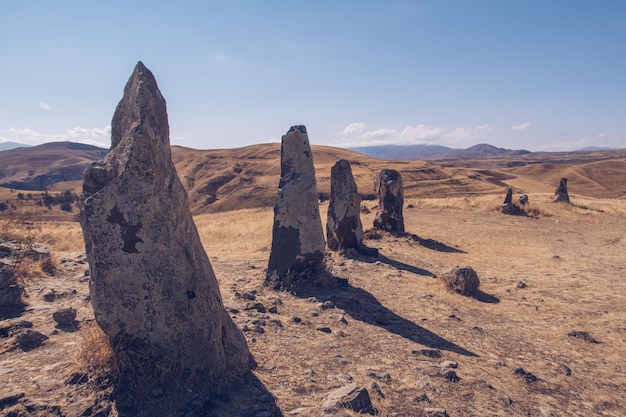 Megalithic standing stones and burial mound of Zorats Karer or Carahunge prehistoric monument in Armenia Armenian Stonehenge stock photography